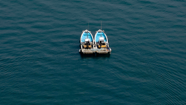 Two boats in water, photo by Buddy AN from unsplash