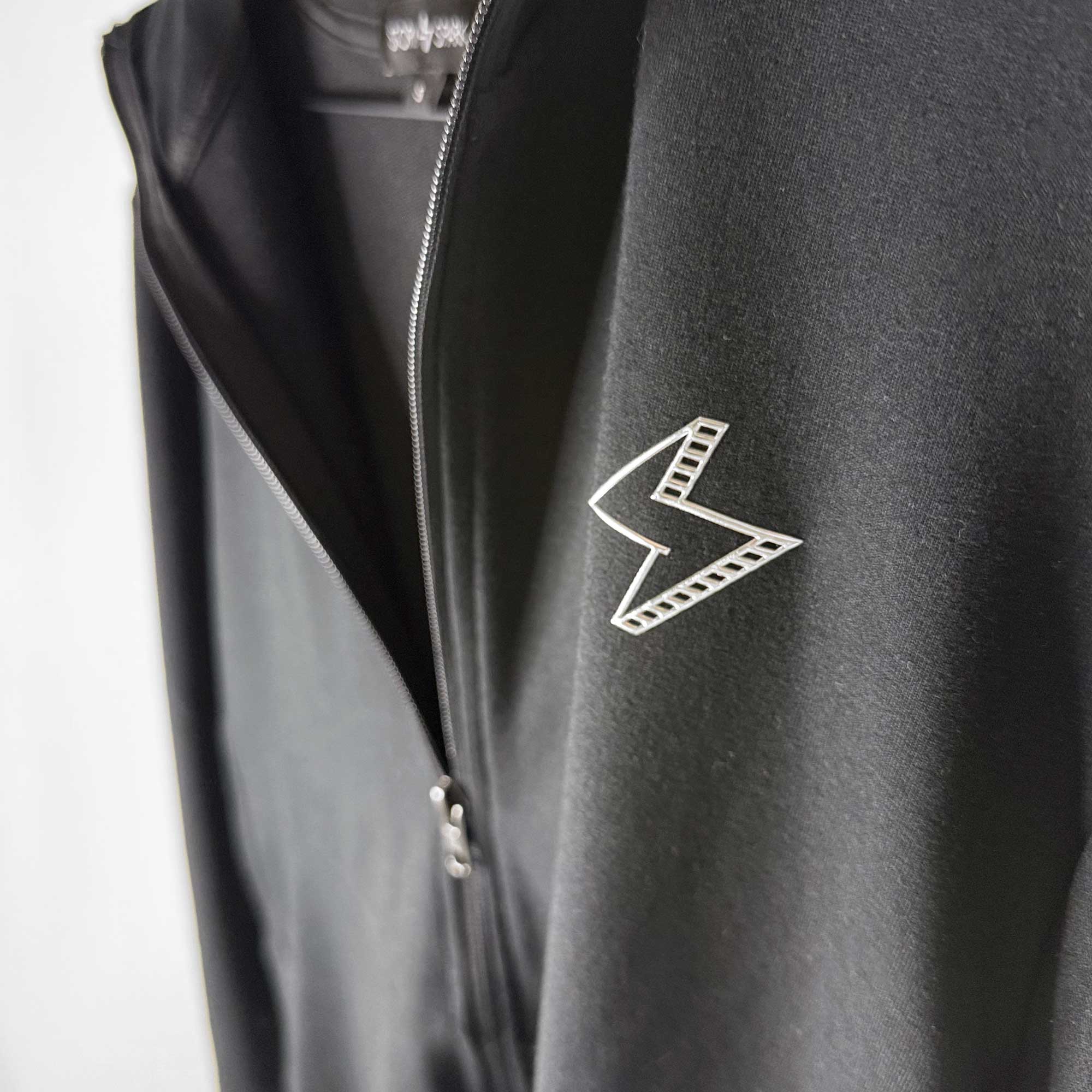 Full zip black jacket with metallic STORY SPARK logo