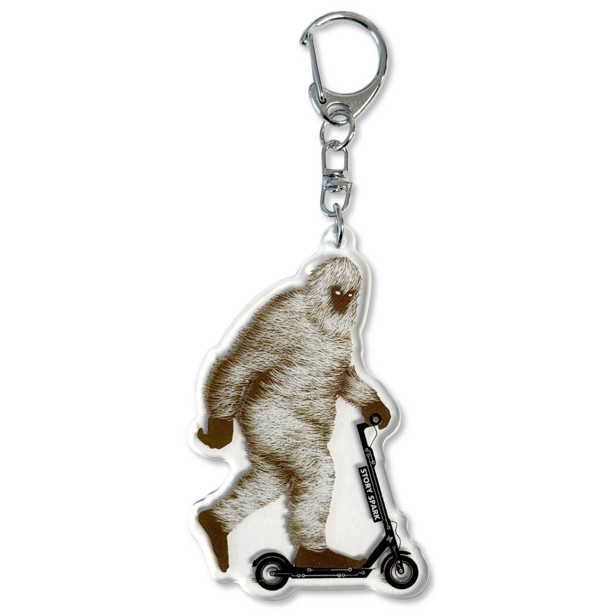 Acrylic keychain with Bigfoot riding a scooter on a white background