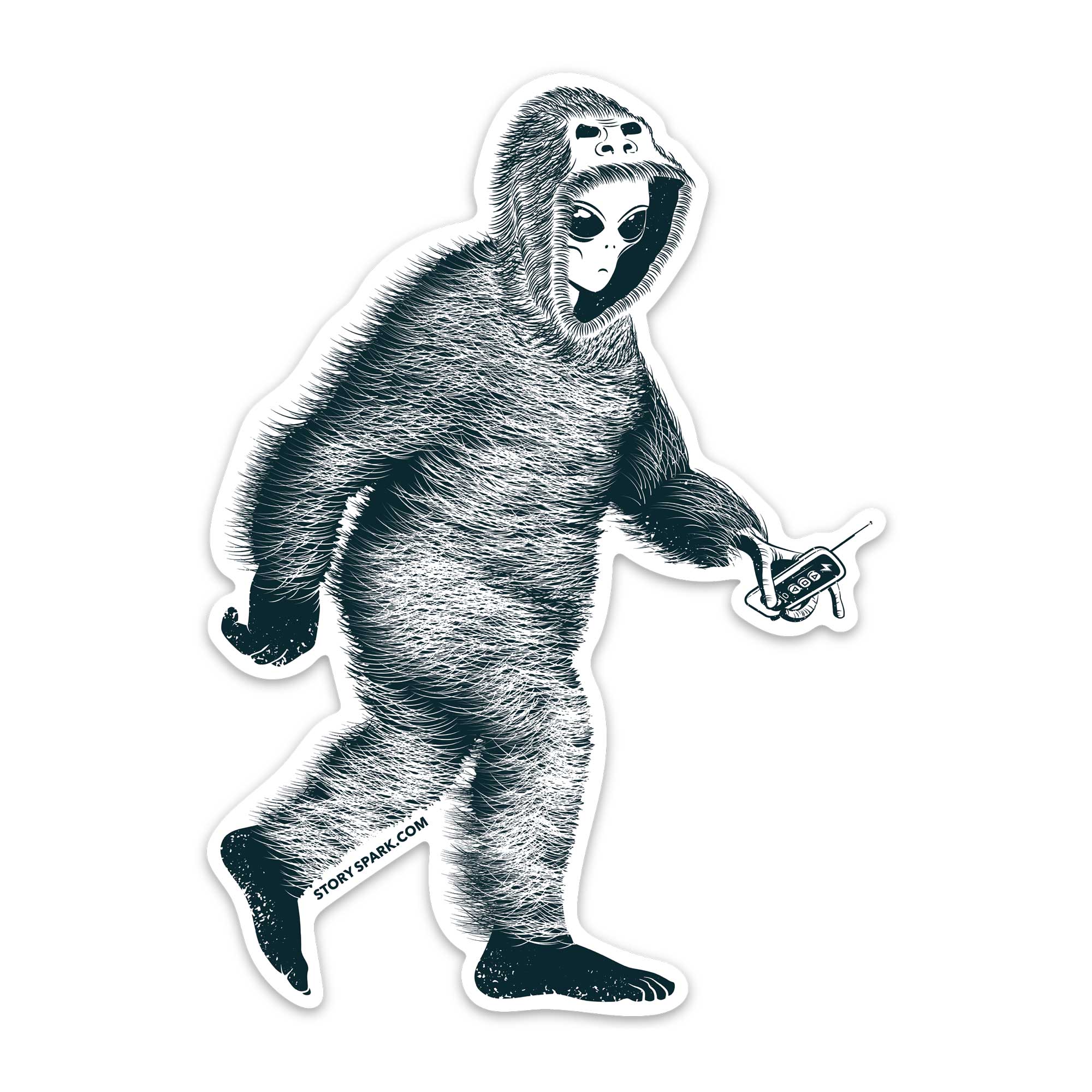 A die-cut sticker featuring a black and white graphic illustration of an alien wearing a Bigfoot suit and holding a remote control, shown on a plain white background.