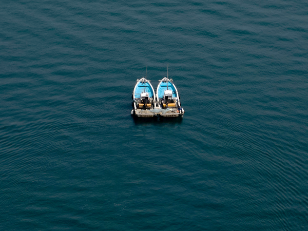 Two boats in water, photo by Buddy AN from unsplash