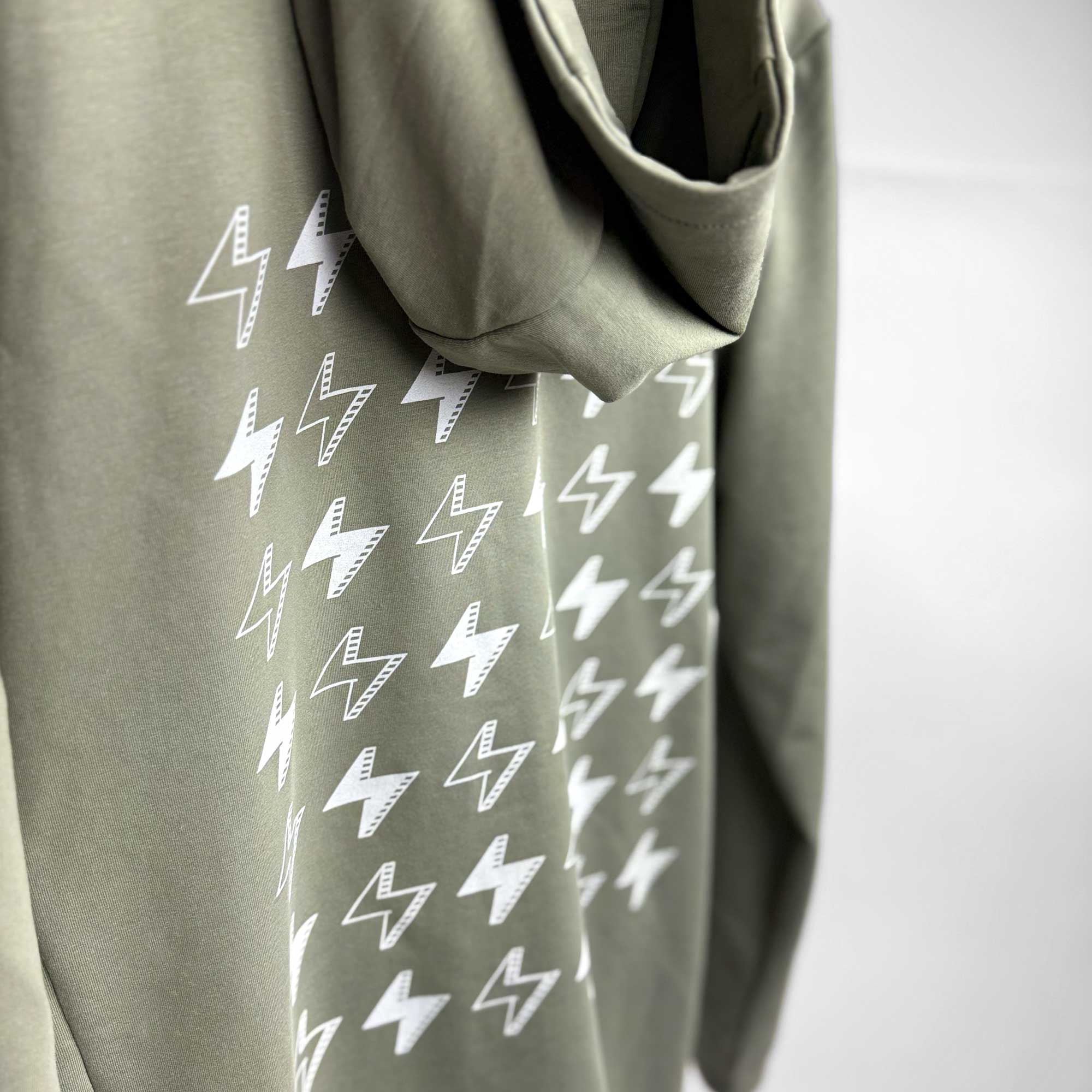 Closeup of olive green Ignite hooded jacket by STORY SPARK