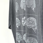 Gray t-shirt with white geometric brain design on a plain background